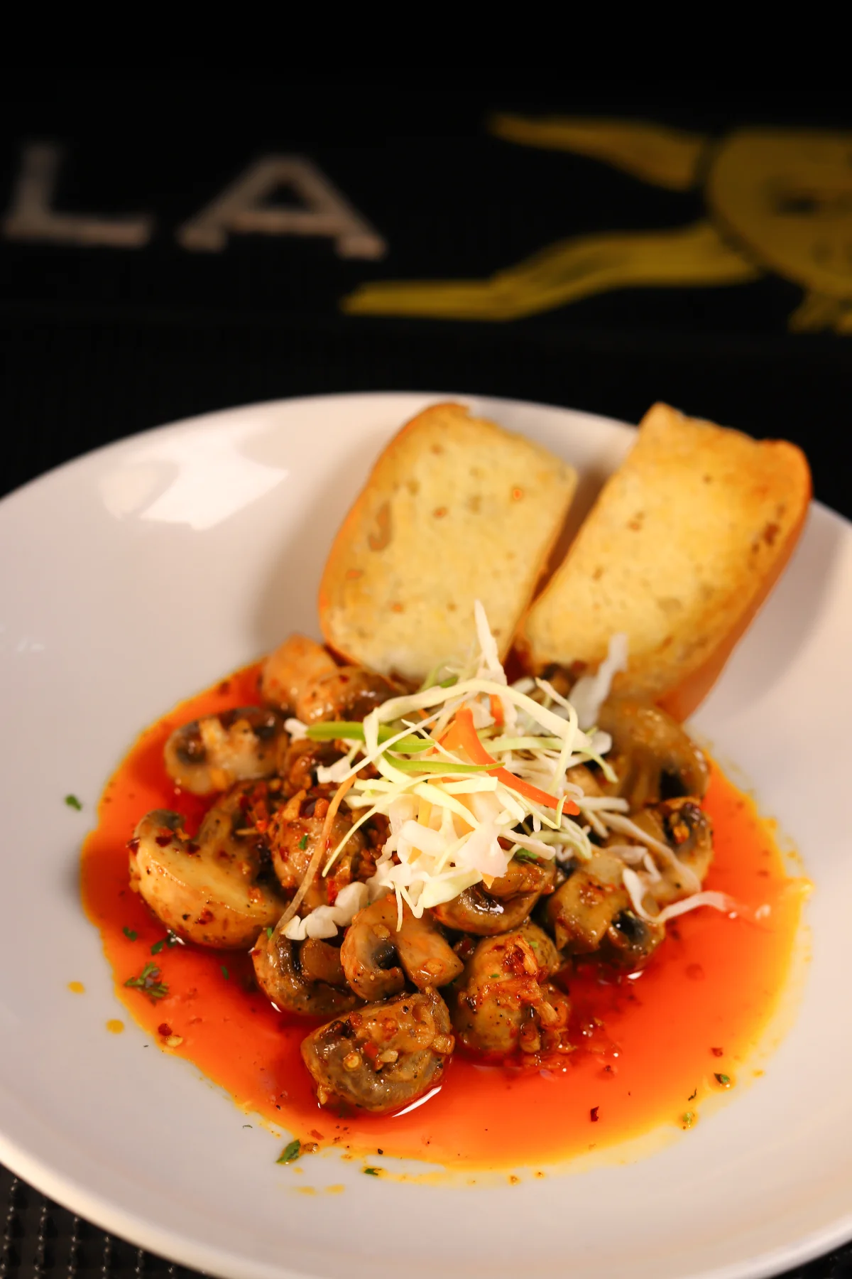 Chef garnishing signature pasta plate Brew Meister